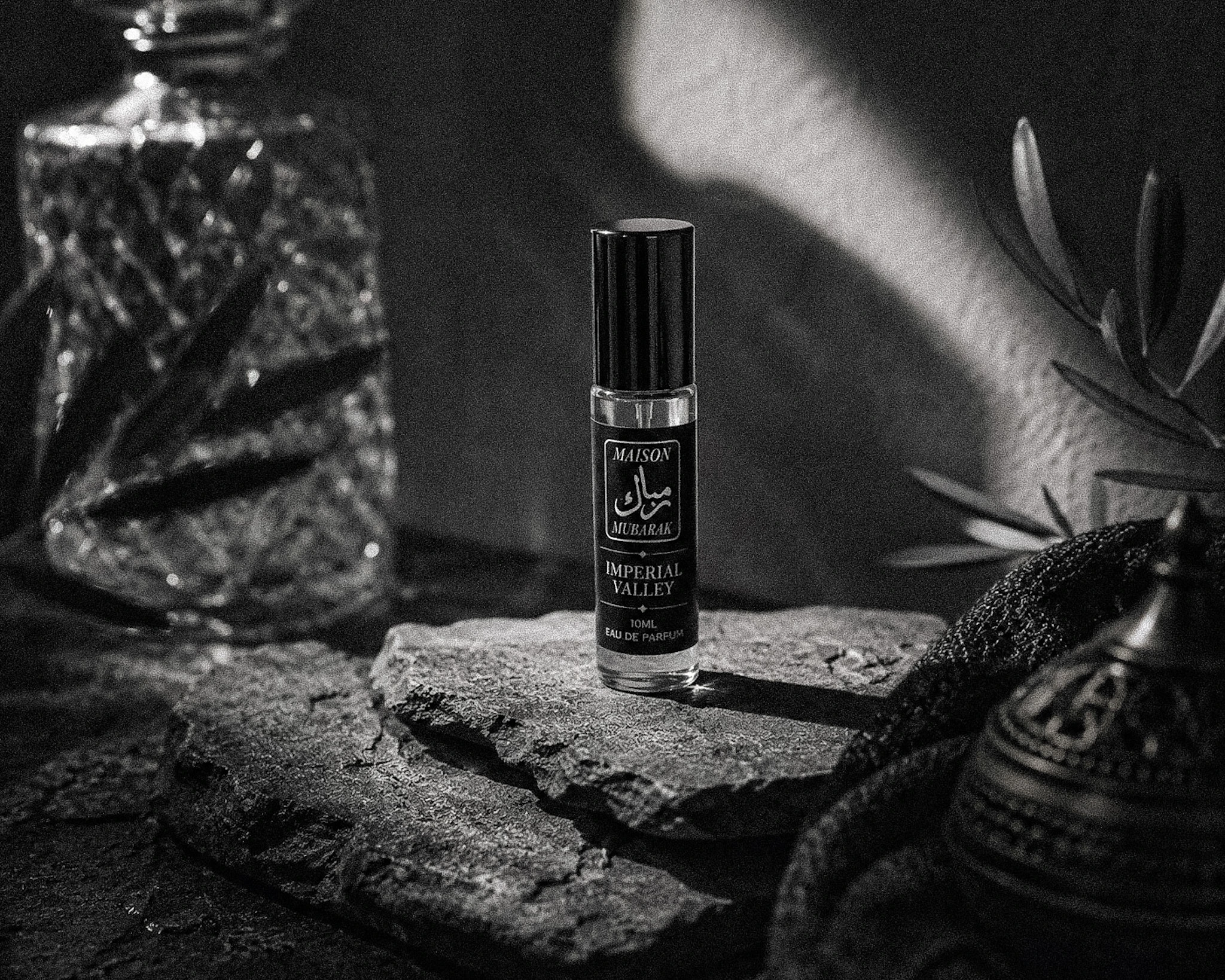 Maison Mubarak fragrance bottles arranged in a monochrome still life.